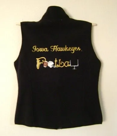 A black vest with the word " iowa hawkeyes football ".