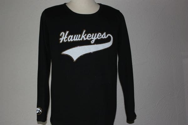 A black long sleeve shirt with the word " hawkeyes " on it.