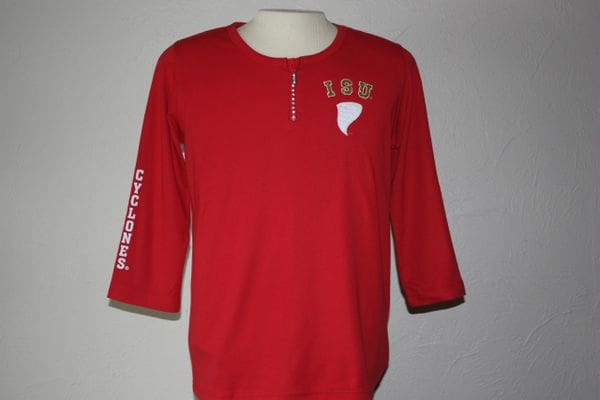 A red shirt with a white and gold design on it.